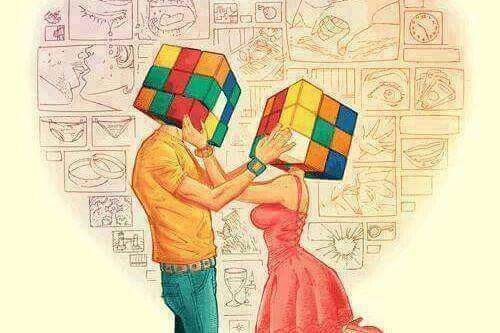 Mann und Frau befühlen den Kopf des jeweils anderen, der ein Rubikwürfel ist