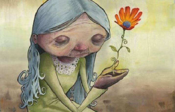 Alte Frau pflanzt Blume