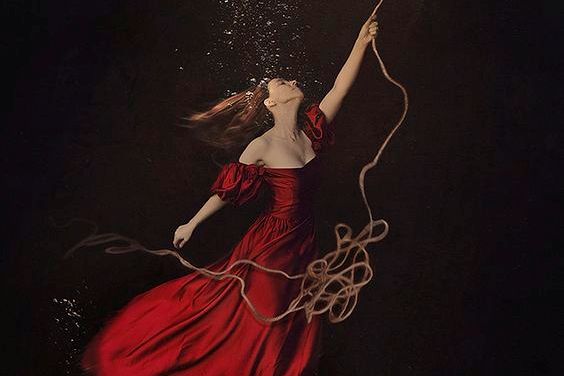 Frau wird an einem Seil nach oben gezogen