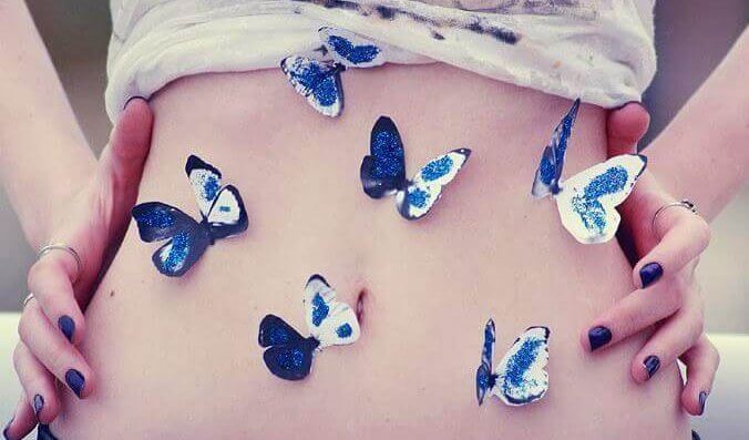 Schmetterlinge auf dem Bauch einer Frau