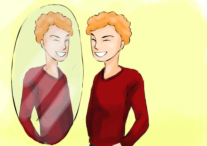 Ein junger Mann im roten Pullover lächelt sich im Spiegel zu.