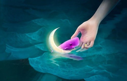 Hände greifen nach pinkfarbenem Wal auf dem Mond