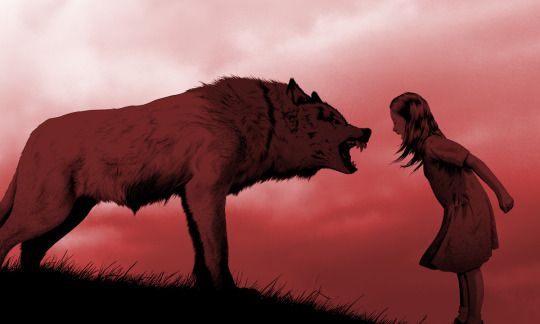Mädchen faucht einen Wolf an