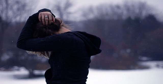 Frau schlägt ihre Hände über dem Kopf zusammen