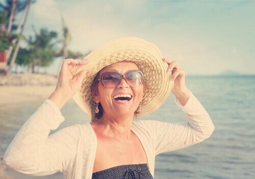 Lachende ältere Frau am Strand