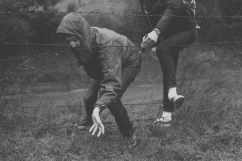 Freunde, die durch einen Zaun klettern