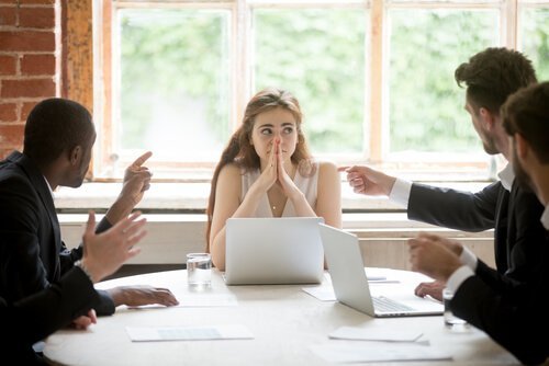 Eine Frau befindet sich in einem Meeting mit Männern.