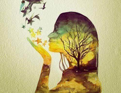 Frau pustet Sterne von ihrer Hand