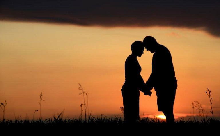 Paar, das sich bei Sonnenuntergang an den Händen hält