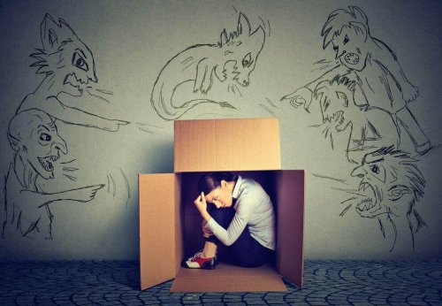 Eine Frau sitzt in einer Kiste. Um sie herum sind böse Figuren gezeichnet.