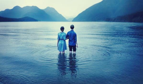 Paar steht inmitten eines Sees