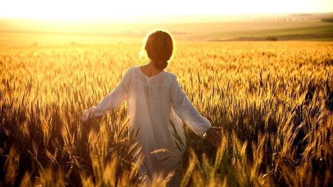 Frau, die in einem Feld spaziert
