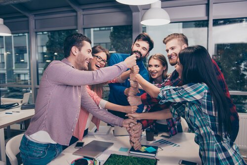 Arbeitskollegen, die ihre Hände zu einem Turm aufbauen