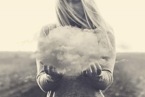 Frau hält eine Wolke fest, die negative Gedanken repräsentiert