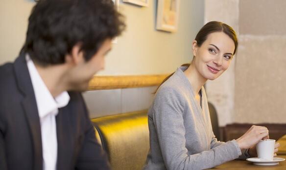 Mann lächelt eine Frau in einem Café an
