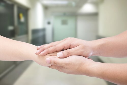 Eine Hand hält eine andere Hand.