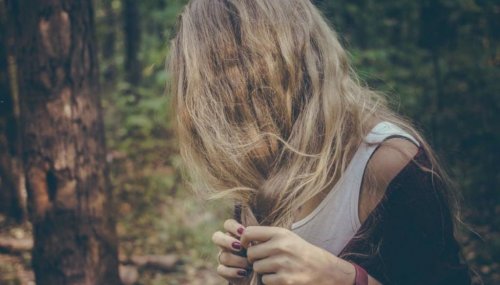 Eine Frau dreht sich von der Kamera fort und will kein Bild von sich machen lassen.