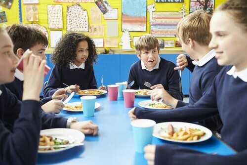 In der Schulcafeteria können Kinder Tischmanieren lernen.