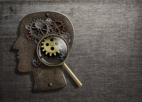 Der Kopf einer Person, unter einer Lupe betrachtet, der die Mechanismen des Geistes zum Vorschein kommen lässt