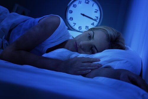 Frau im Bett wacht mitten in der Nacht auf