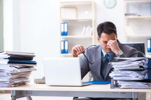 Überarbeiteter Angestellter im Büro: niemand ist unersetzbar!