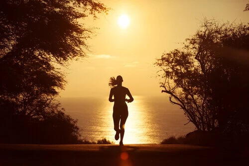 Laufen als Form der Meditation: Eine Frau läuft in den Sonnenuntergang.